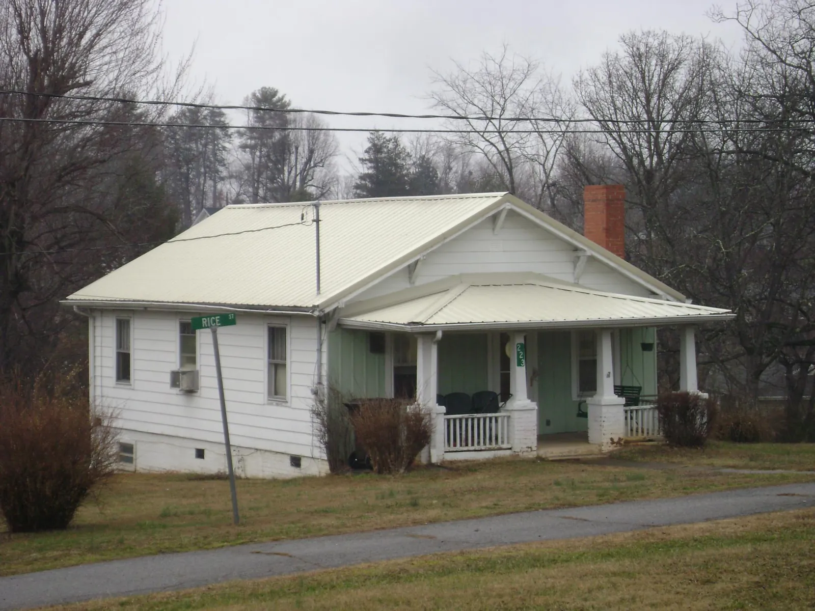 White metal roof on a craftsman bungalow at a street corner in Panacea